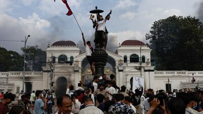 Demonstrators celebrate after successfully storming the Singha Durbar office complex, that houses the Prime Minister's office and other ministries, during a protest against Monday's killing of 19 people after anti-corruption protests that were triggered by a social media ban, which was later lifted, during a curfew in Kathmandu, Nepal, (REUTERS) Demonstrators celebrate after successfully storming the Singha Durbar office complex, that houses the Prime Minister's office and other ministries, during a protest against Monday's killing of 19 people after anti-corruption protests that were triggered by a social media ban, which was later lifted, during a curfew in Kathmandu, Nepal, (REUTERS)