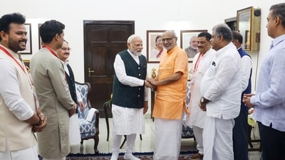 Prime Minister Narendra Modi congratulates CP Radhakrishnan on being elected as the Vice President of India, in New Delhi on Tuesday. (ANI)