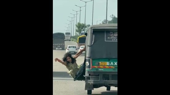 A screen grab of the woman hanging from the moving auto on the Jalandhar bypass on Tuesday. (HT Photo)