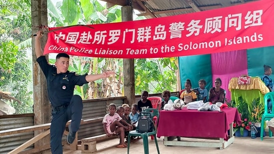In this undated handout photo released by the Royal Solomon Islands Police Force, a member of the Chinese Police Liaison Team performs during a ‘community engagement event’ in the capital of Honiara, in the Pacific nation of Solomon Islands. (Via AFP)