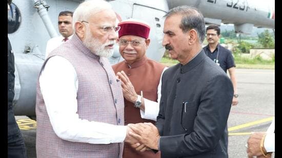 Prime Minister Narendra Modi being received by chief minister Sukhvinder Singh Sukhu at the Gaggal airport in Kangra on Tuesday. Governor Shiv Pratap Shukla is also seen. (HT Photo)