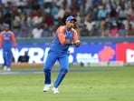 India's Suryakumar Yadav takes a catch to dismiss United Arab Emirates' Junaid Siddique 