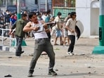 A protester wields a firearm as demonstrators gather outside the Singha Durbar palace complex during a protest in Kathmandu.