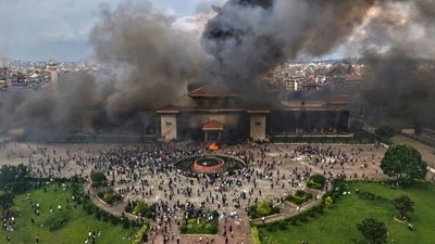 Protesters celebrate at the Singha Durbar, the seat of Nepal's government's various ministries and offices after it was set on fire during a protest. (AP) Protesters celebrate at the Singha Durbar, the seat of Nepal's government's various ministries and offices after it was set on fire during a protest. (AP)