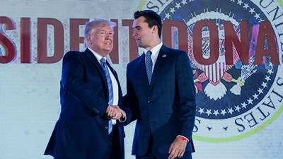 President Donald Trump shakes hands with Charlie Kirk, head of Turning Point USA (AFP) President Donald Trump shakes hands with Charlie Kirk, head of Turning Point USA (AFP)