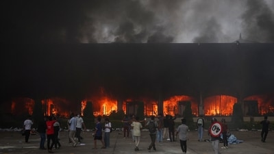 A fire burns inside the Parliament complex during a protest against Monday's killing of 19 people after anti-corruption protests that were triggered by a social media ban. (Adnan Abidi/Reuters)