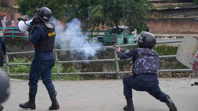 A policemen fires a tear gas shell towards protesters during clashes outside the parliament building in Kathmandu, Nepal. (AP)