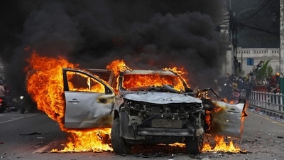 A car burns outside the Singha Durbar, the main administrative building of the Nepal government, in Kathmandu. Nepali demonstrators set parliament ablaze, while the veteran prime minister quit, as a ‘Gen Z’ protest movement sparked by a ban on social media overtook the Himalayan nation.&nbsp; (Prabin Ranabhat/AFP)