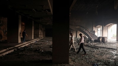 Members of the media walk inside the Parliament house which was set on fire by protesters, following Monday's killing of 19 people after anti-corruption protests that were triggered by a social media ban, which was later lifted, in Kathmandu. (Adnan Abidi/Reuters)
