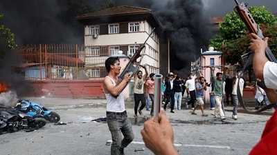 Demonstrators carrying weapons, taken from the supreme court, take part in a protest against Monday's killing of 19 people after anti-corruption protests that were triggered by a social media ban, outside the supreme court in Kathmandu, Nepal. (Bikram Rai/Reuters)