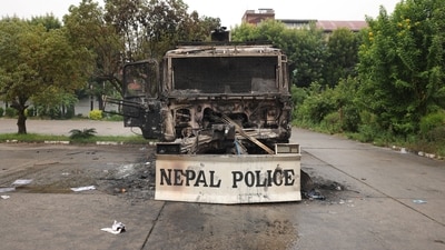 Charred remains of a Nepal Police vehicle sit inside the Parliament house in Kathmandu which was set on fire by protesters. (Adnan Abidi/Reuters)
