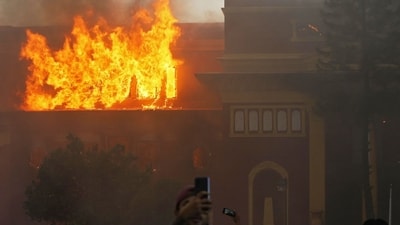 Smoke billows from the burning President House, set ablaze by protesters in Kathmandu. (Prabin Ranabhat/AFP)