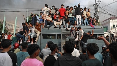 Protesters gather on a security vehicle outside the Singha Durbar, the main administrative building of the Nepal government, in Kathmandu. (Prabin Ranabhat/AFP)