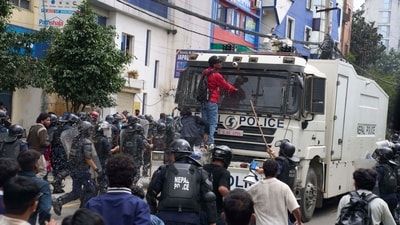 Protesters shout slogans in front of an armored vehicle outside the Parliament building in Kathmandu, Nepal. (Niranjan Shrestha/AP)