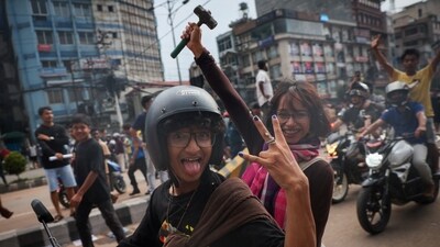 Demonstrators celebrate outside the Parliament complex during a protest in Kathmandu, Nepal. (Adnan Abidi/Reuters)
