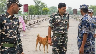 SSB personnel with Nepal’s Armed Police Force (APF) personnel after the India-Nepal border was sealed for regular movement. (PTI photo)