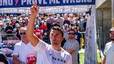 U.S. right-wing activist and commentator Charlie Kirk throws hats to the crowd shortly before he was shot at a Utah Valley University. (via REUTERS)