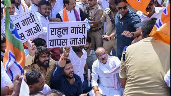 Uttar Pradesh minister Dinesh Pratap Singh stages a protest on the Lucknow-Prayagraj highway. (PTI PHOTO)
