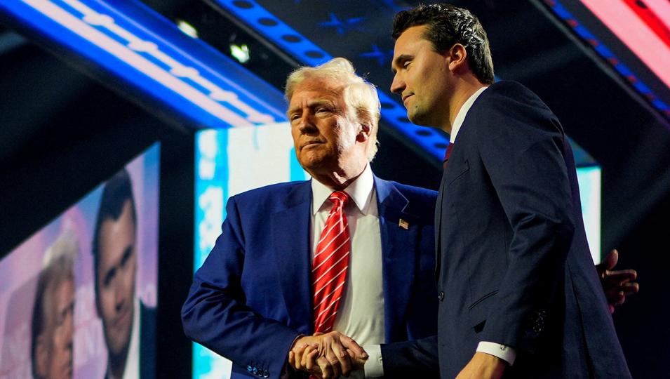 .S. President-elect Donald Trump shakes hands with Turning Point USA founder Charlie Kirk, at Turning Point USA’s AmericaFest in Phoenix, Arizona, U.S., December 22, 2024 (REUTERS)