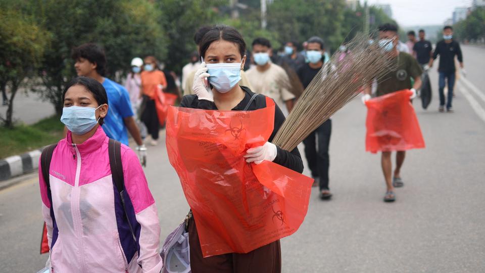 A woman carries a broom and a garbage bag as people head to clean the city, during a curfew following Monday’s killing of 19 people after anti-corruption protests that were triggered by a social media ban, which was later lifted, in Kathmandu, Nepal, September 10 (REUTERS) A woman carries a broom and a garbage bag as people head to clean the city, during a curfew following Monday’s killing of 19 people after anti-corruption protests that were triggered by a social media ban, which was later lifted, in Kathmandu, Nepal, September 10 (REUTERS)