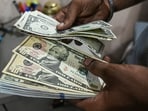 An employee counts US dollar banknotes at a currency exchange in New Delhi, India, on Aug. 30 An employee counts US dollar banknotes at a currency exchange in New Delhi, India, on Aug. 30