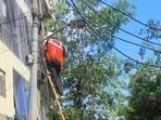 MCG workers repair a streetlight at Saraswati Vihar in Maruti Housing Colony during the “Mission Bright Gurugram” drive, in Gurugram, Wednesday. (HT Photo) MCG workers repair a streetlight at Saraswati Vihar in Maruti Housing Colony during the “Mission Bright Gurugram” drive, in Gurugram, Wednesday. (HT Photo)
