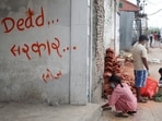 People clean a street next to graffiti that reads "dead government", during a curfew following Monday's killing of 19 people after anti-corruption protests that were triggered by a social media ban, which was later lifted, in Kathmandu, Nepal, September 10, 2025. REUTERS/Adnan Abidi