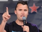 Charlie Kirk speaks while wearing a shirt with a picture taken during Republican presidential nominee and former US President Donald Trump's attempted assassination on Day 3 of the Republican National Convention (RNC), at the Fiserv Forum in Milwaukee, Wisconsin, U.S., July 17, 2024.