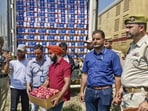 Workers loading apple boxes onto the first parcel train from Kashmir to Delhi, at Budgam railway station in Srinagar on Thursday. (PTI Photo)