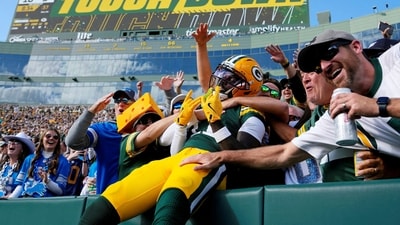 Sep 7, 2025; Green Bay, Wisconsin, USA; Green Bay Packers wide receiver Jayden Reed (11) celebrates with fans after scoring a touchdown against the Detroit Lions during the second quarter at Lambeau Field. (IMAGN IMAGES via Reuters Connect)