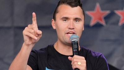 Charlie Kirk speaks while wearing a shirt with a picture taken during Republican presidential nominee and former US President Donald Trump's attempted assassination on Day 3 of the Republican National Convention (RNC), at the Fiserv Forum in Milwaukee, Wisconsin, U.S., July 17, 2024. (File Photo/REUTERS)