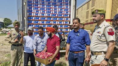Workers loading apple boxes onto the first parcel train from Kashmir to Delhi, at Budgam railway station in Srinagar on Thursday. (PTI Photo) Workers loading apple boxes onto the first parcel train from Kashmir to Delhi, at Budgam railway station in Srinagar on Thursday. (PTI Photo)