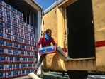 A labourer loading apples boxes in the parcel train from Kashmir to Delhi at Budgam station. (Waseem Andrabi /HT) A labourer loading apples boxes in the parcel train from Kashmir to Delhi at Budgam station. (Waseem Andrabi /HT)