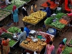 Customers buy fruit and vegetables at an open air evening market in Ahmedabad. 