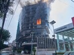 Flames rise from the Hilton hotel after it was set on fire in Nepal's Kathmandu. Flames rise from the Hilton hotel after it was set on fire in Nepal's Kathmandu.