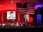 A person holds a U.S. flag during a vigil at Orem City Center Park, after U.S. right-wing activist and commentator, Charlie Kirk was fatally shot.