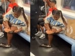 A woman exfoliated her bare feet on a New York subway, sparking outrage online. A woman exfoliated her bare feet on a New York subway, sparking outrage online.
