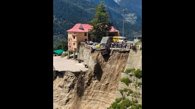 A truck hangs precariously from the edge of a road after a landslide at Sangla, in Kinnaur district, Himachal Pradesh, on Friday. (PTI) A truck hangs precariously from the edge of a road after a landslide at Sangla, in Kinnaur district, Himachal Pradesh, on Friday. (PTI)