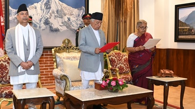 Former Supreme Court Chief Justice Sushila Karki, right, is administered the oath of office by Nepalese President Ram Chandra Poudel, centre, in Kathmandu, Nepal, Friday. (AP)