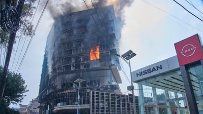 Flames rise from the Hilton hotel after it was set on fire in Nepal's Kathmandu. (AP ) Flames rise from the Hilton hotel after it was set on fire in Nepal's Kathmandu. (AP )