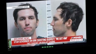 A TV monitor displays a picture of Tyler Robinson, the suspected of killing Charlie Kirk on September 10 (AFP)