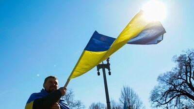 A demonstrator holds a Ukrainian flag during a "Stand with Ukraine" rally against the Russian invasion of Ukraine, in front of the White House in Washington, U.S. (REUTERS)