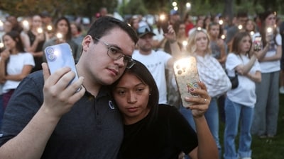 Candles, flowers and flags are left during a candlelight vigil for youth activist and influencer Charlie Kirk at a makeshift memorial at Orem City Center Park in Orem, Utah, a day after he was shot during a public event at Utah Valley University on September 11, 2025. (REUTERS)