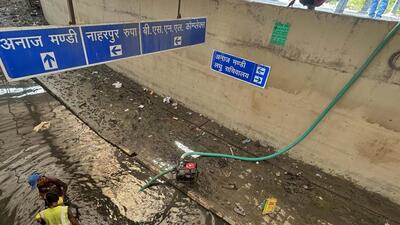 Workers from NHAI seen cleaning and draining rainwater from the non-motorable transport lanes at Rajiv Chowk on Friday. (Parveen Kumar/HT) Workers from NHAI seen cleaning and draining rainwater from the non-motorable transport lanes at Rajiv Chowk on Friday. (Parveen Kumar/HT)