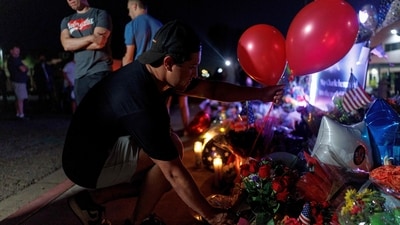 People put flowers and balloons while visiting a memorial for Charlie Kirk at the Turning Point USA headquarters in Phoenix, Arizona. (AFP) People put flowers and balloons while visiting a memorial for Charlie Kirk at the Turning Point USA headquarters in Phoenix, Arizona. (AFP)