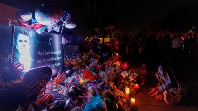 A woman bows at a memorial for Charlie Kirk at the Turning Point USA headquarters in Phoenix, Arizona. (AFP) A woman bows at a memorial for Charlie Kirk at the Turning Point USA headquarters in Phoenix, Arizona. (AFP)
