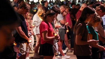 Attendees pray with candles at a Texas A&amp;M University vigil for U.S. right-wing activist and commentator Charlie Kirk shot dead on Wednesday (Reuters)