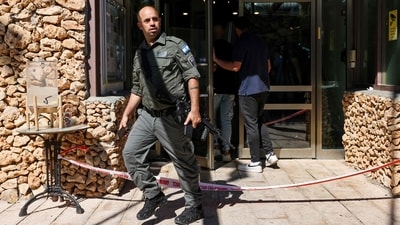 An Israeli border guard walks out of the scene of a stabbing attack in Tzuba (Tzova), on the western outskirts of Jerusalem, on Friday. (AFP)