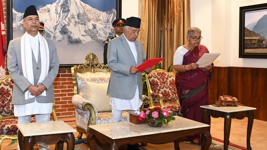 Former Supreme Court Chief Justice Sushila Karki, right, is administered the oath of office by Nepalese President Ram Chandra Poudel, centre, in Kathmandu, Nepal, Friday. (AP)