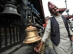 A Hindu devotee rings a bell at Durbar Square in Kathmandu on September 13, 2025, as the capital takes a step towards normalcy following deadly anti-corruption protests.